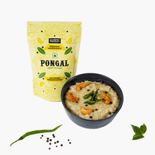 Load image into Gallery viewer, A pack of instant pongal mix with company name on it kept beside a bowl of pongal in it with a chilli, mustard seeds and curry leaves aside.
