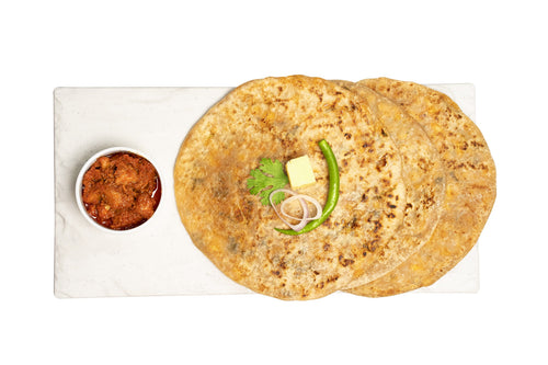 Delicious three achari paneer paratha with some garnishing upon it with achar kept aside.